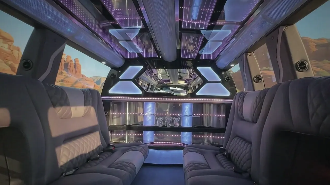 Inside the Cadillac Escalade limo in Colorado: LED light-show ceiling, leather lounge seating and lit bar